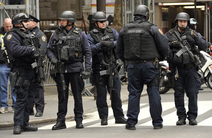 New York Police Department (NYPD) look on as parade participants make their way up 5th Avenue during the 252th New York City St. Patrick's Day Parade on March 16, 2013. AFP PHOTO/TIMOTHY A. CLARY (Photo credit should read TIMOTHY A. CLARY/AFP/Getty Images)