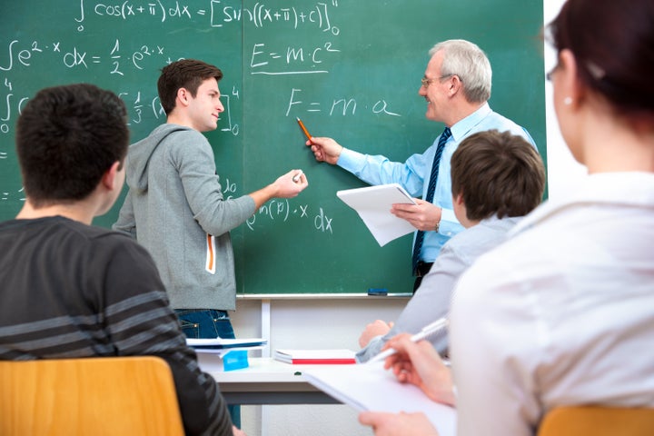 Teacher with a group of high school students in classroom