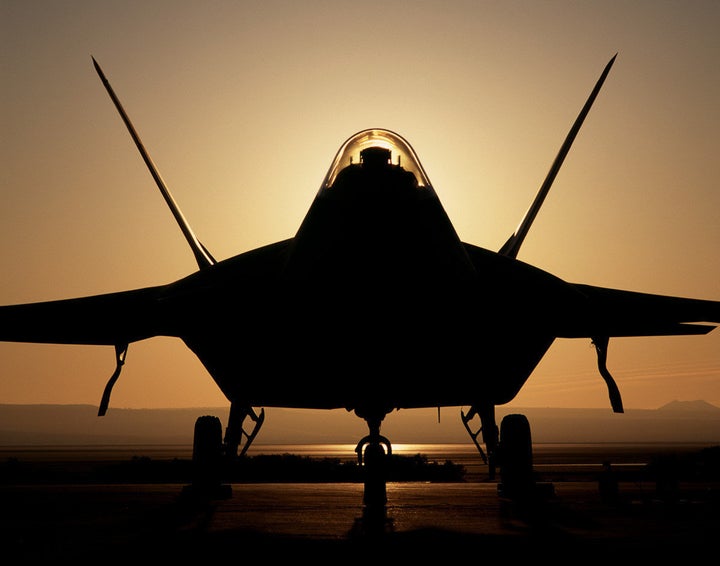 393295 05: (FILE PHOTO) An F-22 Raptor 4001 stealth fighter is silhouetted against the setting sun in this undated file photo. The Pentagon gave Lockheed Martin approval August 15, 2001 to begin production of the stealth jet to replace the Air Force''s F-15 fighters. (Photo courtesy of United States Air Force/Kevin Robertson/Getty Images)