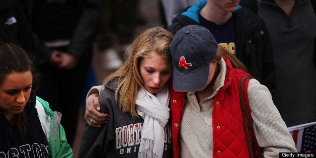 BOSTON, MA - APRIL 16: Two mourners hug during a vigil for victims of the Boston Marathon bombings at Boston Commons on April 16, 2013 in Boston, Massachusetts. The twin bombings, which occurred near the marathon finish line, resulted in the deaths of three people while hospitalizing at least 140. The bombings at the 116-year-old Boston race, resulted in heightened security across the nation with cancellations of many professional sporting events as authorities search for a motive to the violence. (Photo by Spencer Platt/Getty Images)