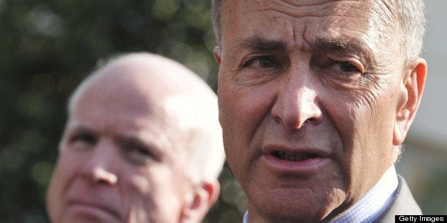 Senator Chuck Schumer, D-NY, speaks to reporters as Senator John McCain (L), R-AZ, looks on after a meeting with US President Barack Obama to brief him on the draft of a bipartisan immigration reform bill outside of the West Wing of the White House on April 16, 2013 in Washington, DC. AFP PHOTO/Mandel NGAN (Photo credit should read MANDEL NGAN/AFP/Getty Images)