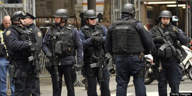 New York Police Department (NYPD) look on as parade participants make their way up 5th Avenue during the 252th New York Cit