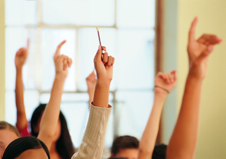 Students Raising Their Hands in a Classroom