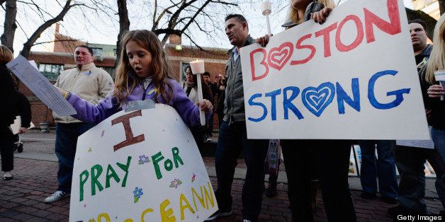 BOSTON, MA - APRIL 21: Adriana Passacantilli, 7, and her mother Sue participate in a candelight vigil for Roseann Sdoia who was seriously injured during the Boston Marathon bombings on April 21, 2013 in Boston, Massachusetts. A manhunt for Dzhokhar A. Tsarnaev, 19, a suspect in the Boston Marathon bombing ended after he was apprehended on a boat parked on a residential property in Watertown, Massachusetts. His brother Tamerlan Tsarnaev, 26, the other suspect, was shot and killed after a car chase and shootout with police. The bombing, on April 15 at the finish line of the marathon, killed three people and wounded at least 170. (Photo by Kevork Djansezian/Getty Images)
