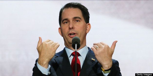 TAMPA, FL - AUGUST 26: Wisconsin Gov. Scott Walker speaks at the podium ahead of the Republican National Convention at the Tampa Bay Times Forum on August 26, 2012 in Tampa, Florida. The RNC is scheduled to convene on August 27 and will hold its first full-day session on August 28 as Tropical Storm Isaac threatens disruptions due to its proximity to the Florida peninsula. (Photo by Chip Somodevilla/Getty Images)