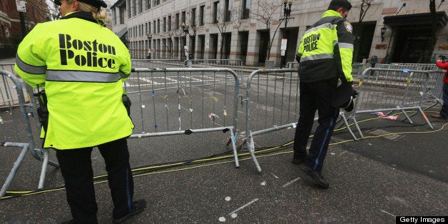 BOSTON, MA - APRIL 23: Police close a barricade along a still closed section of Boylston Street near the site of the Boston Marathon bombings on April 23, 2013 in Boston, Massachusetts . Business owners and residents of the closed section were allowed to return to their properties today while under escort of city staff. (Photo by Mario Tama/Getty Images)