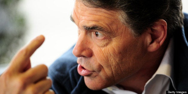 Republican presidential hopeful Rick Perry gestures as he has lunch with supporters at the Drive-In Restaurant in Florence, South Carolina, January 17, 2012. South Carolina will hold its Republican primary on January 21, 2012. AFP PHOTO/Emmanuel Dunand (Photo credit should read EMMANUEL DUNAND/AFP/Getty Images)