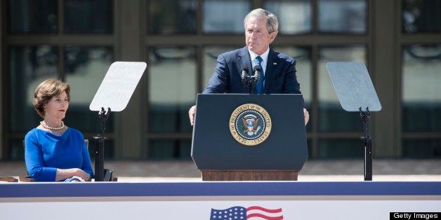 Former First Lady Laura Bush listens while former US President George W. Bush speaks during a dedication ceremony at the Geor