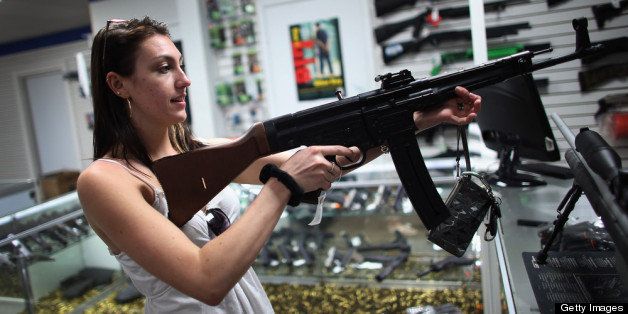 POMPANO BEACH, FL - APRIL 11: As the U.S. Senate takes up gun legislation in Washington, DC , Cristiana Verro looks at guns on sale at the National Armory gun store on April 11, 2013 in Pompano Beach, Florida. The Senate voted 68-31 to begin debate on a bill that would significantly expand background checks for gun sales. (Photo by Joe Raedle/Getty Images)