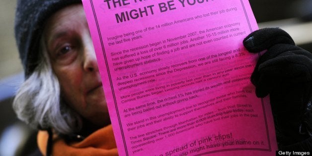 A person takes part in 'THE LINE', a protest representing 14 million unemployed Americans and demanding action from congress and corporations down on Wall Street March 6, 2012. Concerned citizens formed a three-mile line on Broadway, holding paper to look like pink slips from the Bull at Bowling Green to Union Square on Super Tuesday. AFP PHOTO/ TIMOTHY A. CLARY (Photo credit should read TIMOTHY A. CLARY/AFP/Getty Images)