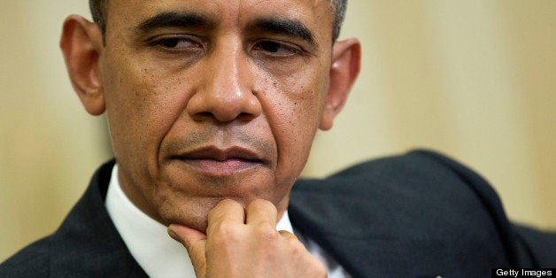 U.S. President Barack Obama listens during a meeting with Hamad bin Khalifa al-Thani, the Amir of Qatar, unseen, in the Oval