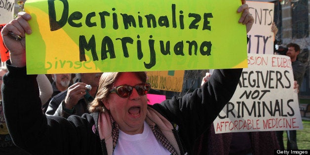 OAKLAND, CA - JANUARY 04: A medical marijuana activist holds a sign during a rally January 4, 2010 in Oakland, California. Dozens of medical marijuna activists held a demonstration outside of the Ronald V. Dellums federal building in Oakland demnanding medical marijuana reform. (Photo by Justin Sullivan/Getty Images)