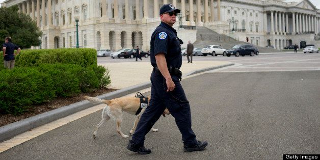 UNITED STATES - APRIL 17: A U.S. Capitol Police K-9 officer patrols the Capitol grounds. Two nearby Senate office buildings were evacuated during today due to suspicious packages and letters.(Photo By Chris Maddaloni/CQ Roll Call)