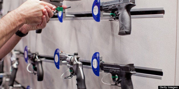 ST. LOUIS, MO - APRIL 14: A visitor handles a revolver at a Smith & Wesson display during the NRA Annual Meetings and Exhibits April 14, 2012 at America's Center in St. Louis, Missouri. More than 60,000 people are expected to attend the convention, which runs through Sunday. (Photo by Whitney Curtis/Getty Images)