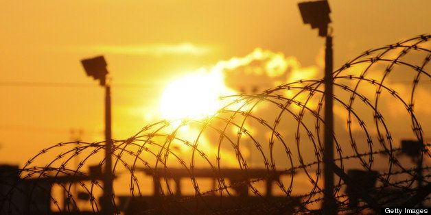 The sun rises over the Camp Delta detention center at the U.S. naval base at Guantanamo Bay, Cuba, on Thursday, Oct. 18, 2012. Khalid Sheikh Mohammed, the accused mastermind of the Sept. 11, 2001, terrorist attacks, urged a military judge at the U.S. naval base at Guantanamo Bay yesterday to avoid using an expansive definition of national security that the defendant said would justify torture and killing. Photographer: Michelle Shepard/Pool via Bloomberg