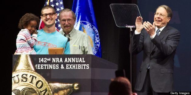 Elaih Wagan, a 3-year-old from Austin, Texas is recognized as the youngest lifetime member by Wayne LaPierre(R), executive vice president of the National Rifle Association(NRA), during the142nd annual convention at the George R. Brown Convention Center May 4, 2013 in Houston, Texas. Wagan's grandfather purchased a lifetime membership as a gift for the little girl. AFP PHOTO / Karen BLEIER (Photo credit should read KAREN BLEIER/AFP/Getty Images)