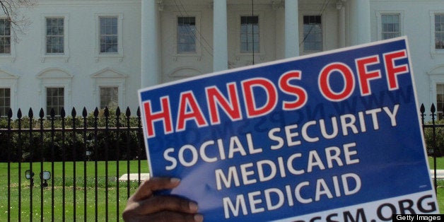 A protest sign is held up in front of the White House on April 9, 2013, in Washington, D.C., where liberal advocacy opposed changes to Social Security benefits proposed by President Obama. (Kevin G. Hall/MCT via Getty Images)