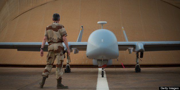 A French soldier of the Serval operation in Mali stands in front of a Harfang drone on April 26, 2013 on the French army base of Niamey. AFP PHOTO / MARTIN BUREAU (Photo credit should read MARTIN BUREAU/AFP/Getty Images)