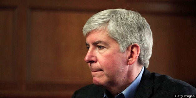 DETROIT, MI - MARCH 1: Michigan Governor Rick Snyder talks with the news media after announcing that he will appoint an Emergency Financial Manager for the city of Detroit during a town hall meeting at Wayne State University March 1, 2013 in Detroit, Michigan. Detroit has more than $14 billion in debts and liabilities. The City has 10 days to appeal Gov. Snyder's decision. (Photo by Bill Pugliano/Getty Images)