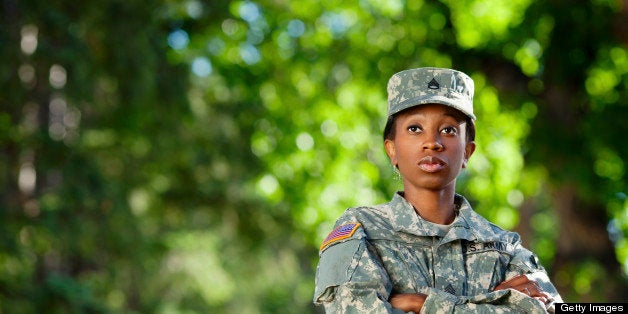 Female African American soldier in army camouflage uniform or ACU and patrol cap.