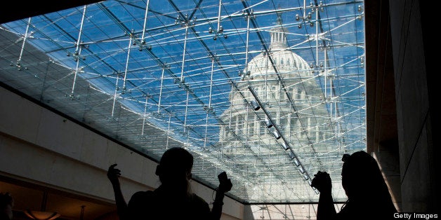 UNITED STATES - May 2: Classmates Susan Sheppard and Connie Byford of Texas take photos of the U.S. Capitol dome from the Capitol Visitors Center skylight area on May 2, 2013. (Photo By Douglas Graham/CQ Roll Call)