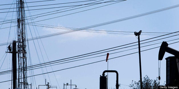 A pumpjack operates near a hydraulic fracturing (fracking) test well at the Inglewood Oil field in Los Angeles, California, U
