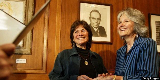 CAMBRIDGE - MAY 17: Cambridge City Hall -- At Cambridge City Hall, Marcia Kadish (left) and Tanya McCloskey exchange rings as they are married before Clerk D. Margaret Drury at Cambridge City Hall. They were the first couple to be married in Cambridge on Monday morning. (Photo by Dina Rudick/The Boston Globe via Getty Images)