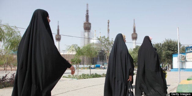 TEHRAN, IRAN - AUGUST 14: Iranian women in chadors walk at the Holy Shrine mausoleum of Ayatollah Khomeini on August 14, 2012