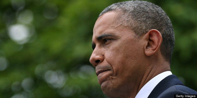 WASHINGTON, DC - MAY 16: U.S. President Barack Obama looks to see if it stopped raining as a U.S. Marine holds an umbrella for hims, during a news conference with Prime Minister Recep Tayyip Erdogan of Turkey (not shown), in the Rose Garden at the White House, May 16, 2013 in Washington, DC. President Obama answered questions on the IRS Justice Department invesigation. (Photo by Mark Wilson/Getty Images)