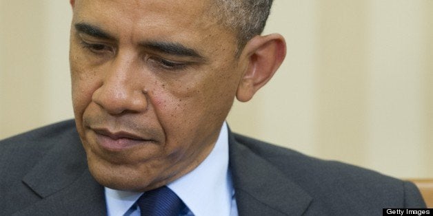 US President Barack Obama listens during a meeting with President Thein Sein of Myanmar in the Oval Office of the White House