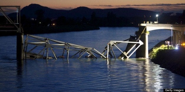 MT. VERNON, WASHINGTON - MAY 23: Crews survey the scene of a bridge collapse on Interstate 5 on May 23, 2013 near Mt. Vernon, Washington. I-5 connects Seattle, Washington to Vancouver B.C., Canada. No deaths have been reported, and three people were taken to hospitals with injuries. (Stephen Brashear/Getty Images)