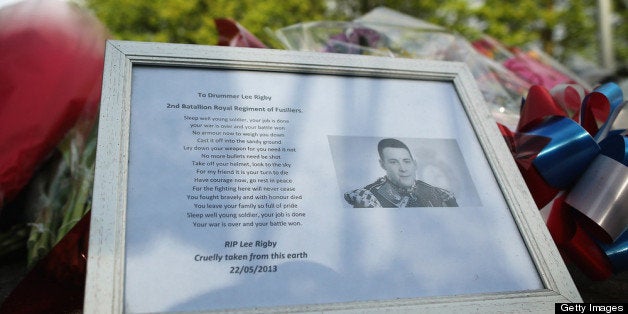 LONDON, ENGLAND - MAY 23: A framed picture of Drummer Lee Rigby of the 2nd Battalion the Royal Regiment of Fusiliers who was killed yesterday, lays with flowers outside Woolwich Barracks on May 23, 2013 in London, England. Drummer Lee Rigby of the 2nd Battalion the Royal Regiment of Fusiliers was murdered by suspected Islamists near London's Woolwich Army Barracks yesterday. British Prime Minister David Cameron has said that the 'appalling' attack appeared to be terror related. (Photo by Dan Kitwood/Getty Images)