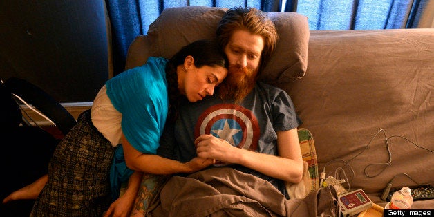 Tomas Young, a paralyzed Iraq vet who became an outspoken critic against the war and subject of the documentary 'Body of War,' has a quiet moment with his wife, Claudia Cuellar, in Kansas City, Missouri on March 20, 2013. (Jill Toyoshiba/Kansas City Star/MCT via Getty Images)