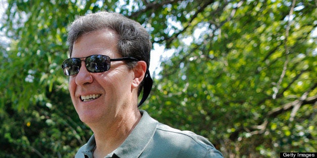 Kansas governor Sam Brownback, right, listens to Marc Murrell, middle, of the Kansas Deptartment of Wildlife, Parks and Touri