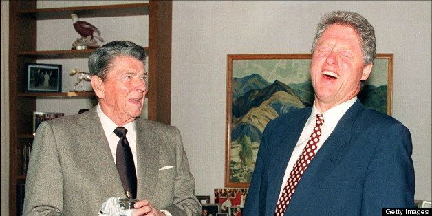 LOS ANGELES, CA - NOVEMBER 27: US President-elect Bill Clinton (r) breaks into a big laugh in Los Angeles 27 November 1992, as former U.S. President Ronald Reagan presents him with a jar of red, white and blue jelly beans that, Reagan said, kept him from going to cigarettes. Clinton said he wanted to talk with Reagan about his transition. (Photo credit should read PAUL RICHARDS/AFP/Getty Images)