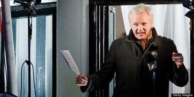 Wikileaks founder Julian Assange addresses members of the media and supporters from the window of the Ecuadorian embassy in Knightsbridge, west London on December 20, 2012. WikiLeaks will release one million documents next year affecting every country in the world, founder Julian Assange said in a speech from the balcony of the Ecuadorian embassy in London. In a 'Christmas message' marking six months since he sought asylum in the embassy to avoid extradition to Sweden over claims of rape and sexual assault, Assange also said the door was open to negotiations. AFP PHOTO/Leon Neal (Photo credit should read LEON NEAL/AFP/Getty Images)