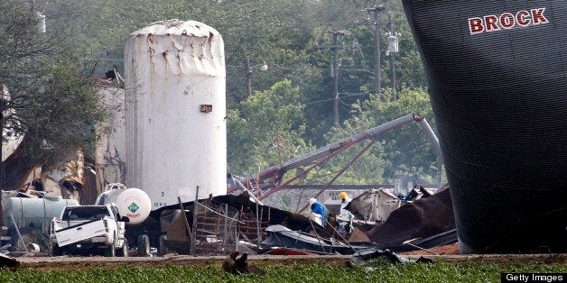 Searchers in protective suits walk through the blast zone of the fertilizer plant that exploded in West, Texas, on Thursday,