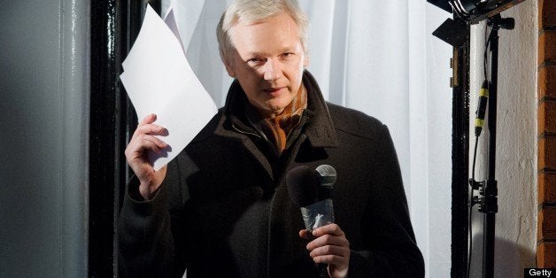 Wikileaks founder Julian Assange addresses members of the media and supporters from the window of the Ecuadorian embassy in Knightsbridge, west London on December 20, 2012. WikiLeaks will release one million documents next year affecting every country in the world, founder Julian Assange said in a speech from the balcony of the Ecuadorian embassy in London. In a 'Christmas message' marking six months since he sought asylum in the embassy to avoid extradition to Sweden over claims of rape and sexual assault, Assange also said the door was open to negotiations. AFP PHOTO/Leon Neal (Photo credit should read LEON NEAL/AFP/Getty Images)