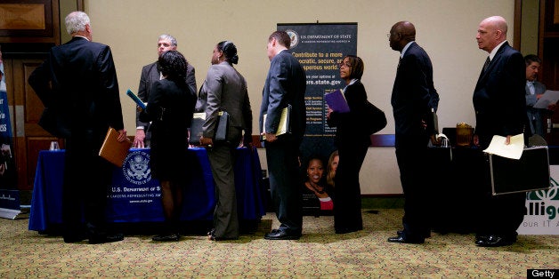 Job seekers wait in line to visit the U.S. Department of State booth at the Choice Career Fairs job fair in Arlington, Virginia, U.S., on Thursday, June 6, 2013. The U.S. Department of Labor is scheduled to release jobless claims figures on June 7. Photographer: Andrew Harrer/Bloomberg via Getty Images