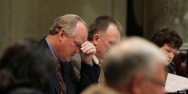 MADISON, WI - MARCH 09: Republican state senator Dale Schultz holds his head during a session of the State Senate at the Wisconsin State Capitol on March 9, 2011 in Madison, Wisconsin. As demonstations continue at the Wisconsin State Capitol against Governor Scott Walker's attempt to push through a bill that would restrict collective bargaining for most government workers in the state, the state senate voted unanimously passed resolutions to impose fines on fourteen senate democrats who fled the state. Each senator will be fined $100 for each day that they do not show up for senate sessions. (Photo by Justin Sullivan/Getty Images)