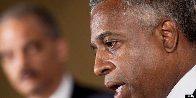WASHINGTON - AUGUST 5: Attorney General Eric H. Holder Jr. (L) listens as B. Todd Jones, U.S. Attorney for the District of M