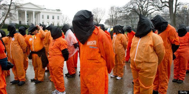 Protesters march against the 10-year anniversary of holding detainees in Guantanamo Prison during a demonstration January 11, 2012 in front of the White House in Washington,DC. The White House insisted Monday that Obama was determined to close Guantanamo, which accepted its first prisoners on January 11, 2002, four months after Al-Qaeda flew hijacked planes into the World Trade Center and Pentagon. AFP Photo/Paul J. Richards (Photo credit should read PAUL J. RICHARDS/AFP/Getty Images)