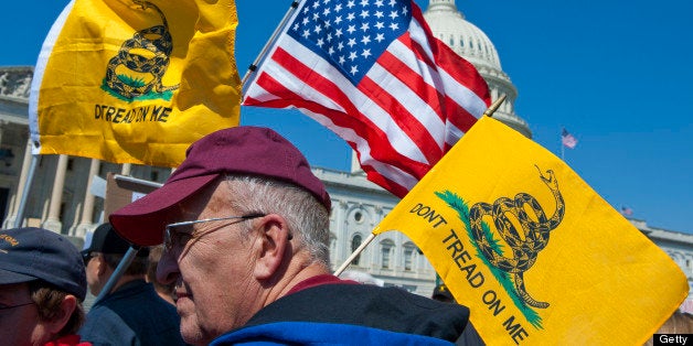 UNITED STATES Ð APRIL 6: Tea party activist on the East Front of the U.S. Capitol hold up signs and flags during a rally on W