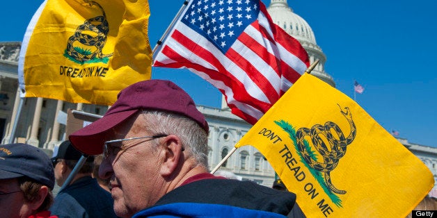 UNITED STATES Ð APRIL 6: Tea party activist on the East Front of the U.S. Capitol hold up signs and flags during a rally on Wednesday, April 6, 2012, days before a possible federal government shutdown. (Photo By Douglas Graham/Roll Call)