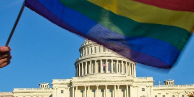 A demonstrator waves a rainbow flag in front of the US Capitol in Washington on October 11, 2009 as tens of thousands of gay activists marched to demand civil rights, a day after President Barack Obama vowed to repeal a ban on gays serving openly in the US military. AFP PHOTO/Maria Belen PEREZ GABILONDO (Photo credit should read Maria Belen Perez Gabilondo/AFP/Getty Images)