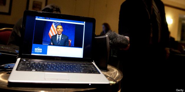 U.S. President Barack Obama is seen on the screen of a laptop computer as he participates in a video teleconference with Iowa Caucus attendees in Washington, D.C., U.S., on Tuesday, Jan. 3, 2012. Obama told his Iowa supporters they need to 'maintain the same determination, the same energy' they had during the 2008 campaign to ensure his re-election in what is likely to be a close 2012 race. Photographer: Joshua Roberts/Bloomberg via Getty Images 
