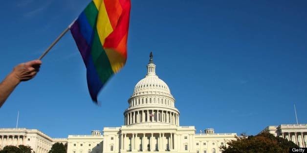 A demonstrator waves a rainbow flag in front of the US Capitol in Washington on October 11, 2009 as tens of thousands of gay activists marched to demand civil rights, a day after President Barack Obama vowed to repeal a ban on gays serving openly in the US military. AFP PHOTO/Maria Belen PEREZ GABILONDO (Photo credit should read Maria Belen Perez Gabilondo/AFP/Getty Images)