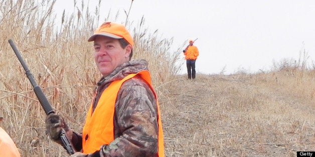 Kansas Gov. Sam Brownback, right, and guide Troy Sporer waited for other hunters before heading into cover during the Kansas Governor's Ringneck Classic in western Kansas. (Brent Frazee/Kansas City Star/MCT via Getty Images)