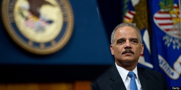 US Attorney General Eric Holder waits to address the Justice Department's Lesbian, Gay, Bisexual and Transgender (LGBT) Pride