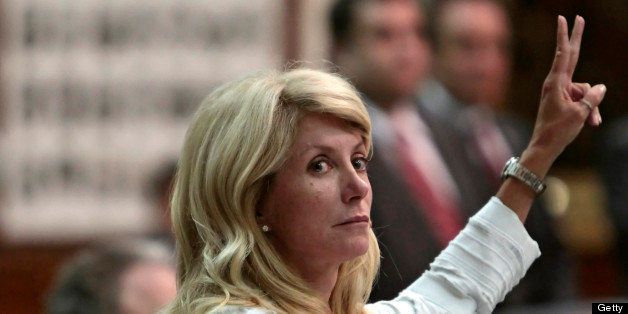 AUSTIN, TX - JUNE 25: State Sen. Wendy Davis (D-Ft. Worth) holds up two fingers against the anti-abortion bill SB5, which was up for a vote on the last day of the legislative special session June 25, 2013 in Austin, Texas. A combination of Sen. Davis' 13-hour filibuster and protests by reproductive rights advocates helped to ultimately defeat the controversial abortion legislation at midnight. (Photo by Erich Schlegel/Getty Images)